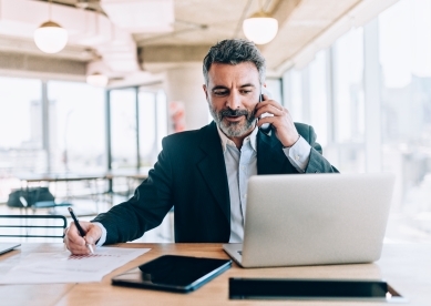 Businessman at the office talking on cell phone